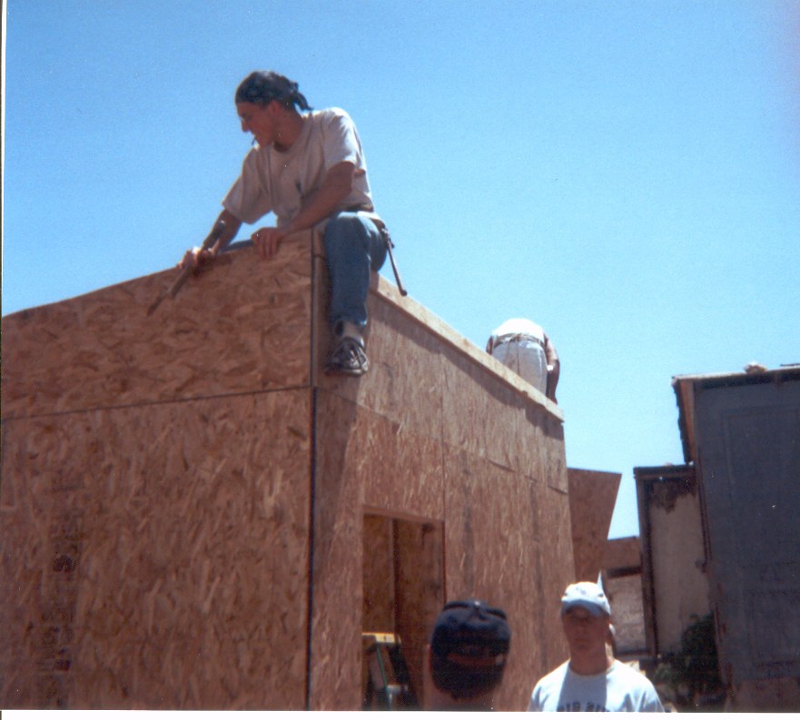 Nailing on the triangle shaped siding pieces on the side of the house